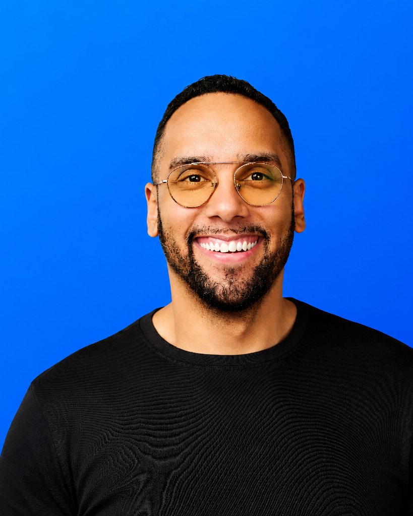 Portrait of Jeremy Jones, founder of Aculeus, in glasses against a signal-blue background