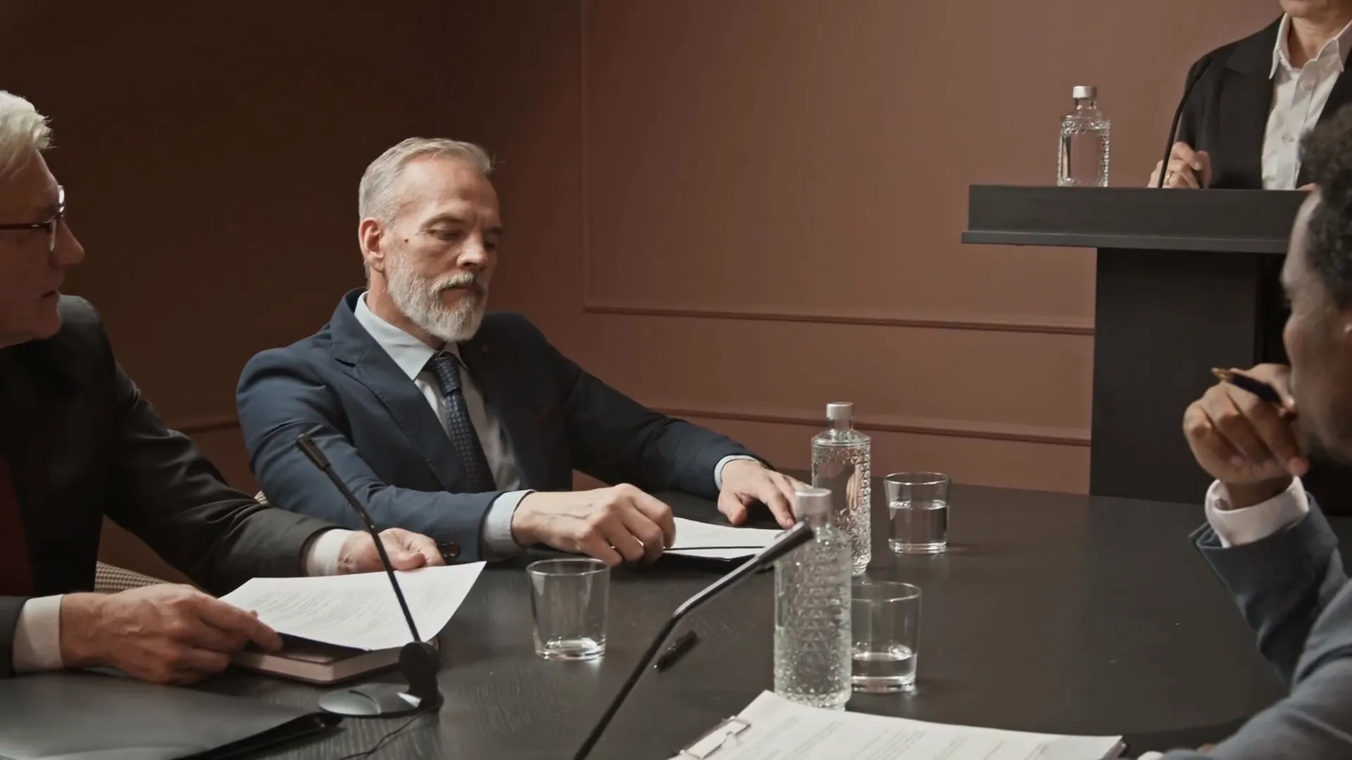 People working through evidence and a decision around a conference table