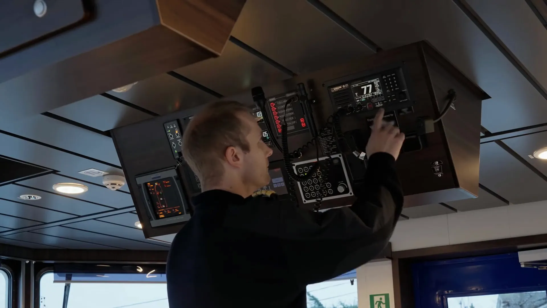 An officer working the communications panel on a ship’s bridge